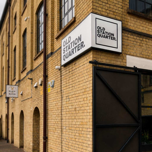 Outside signage for Old Station Quarter and Black & Bloom Coffee
