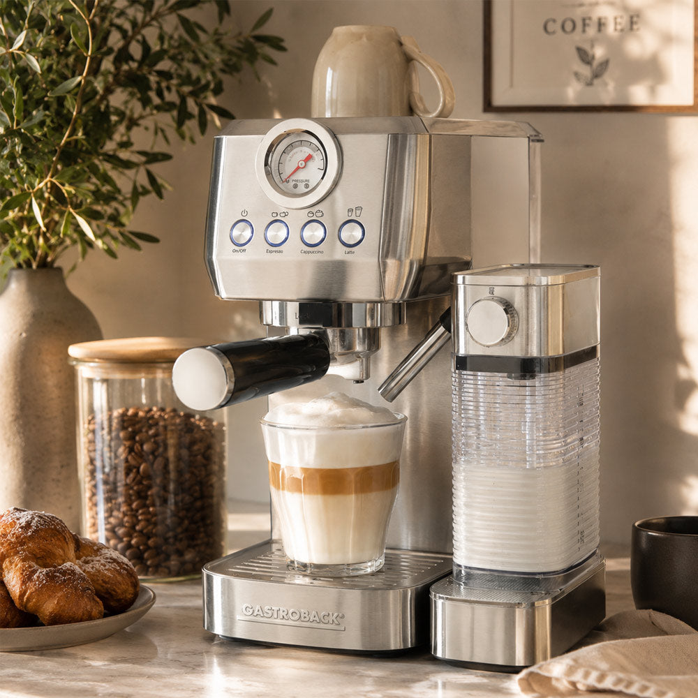 Espresso machine  Gastroback PIccolo Pro with a cup of coffee and pastries on a countertop.