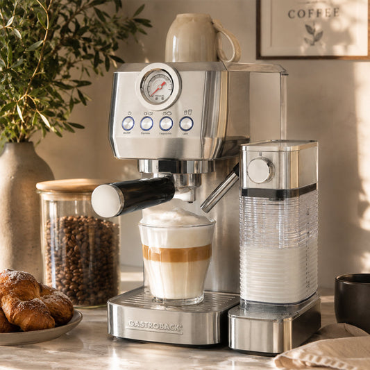 Espresso machine  Gastroback PIccolo Pro with a cup of coffee and pastries on a countertop.